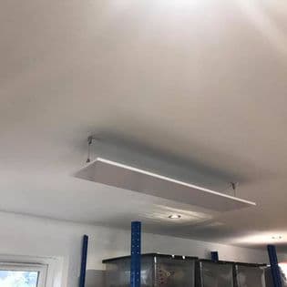 Infrared panel heater installed in a commercial workshop